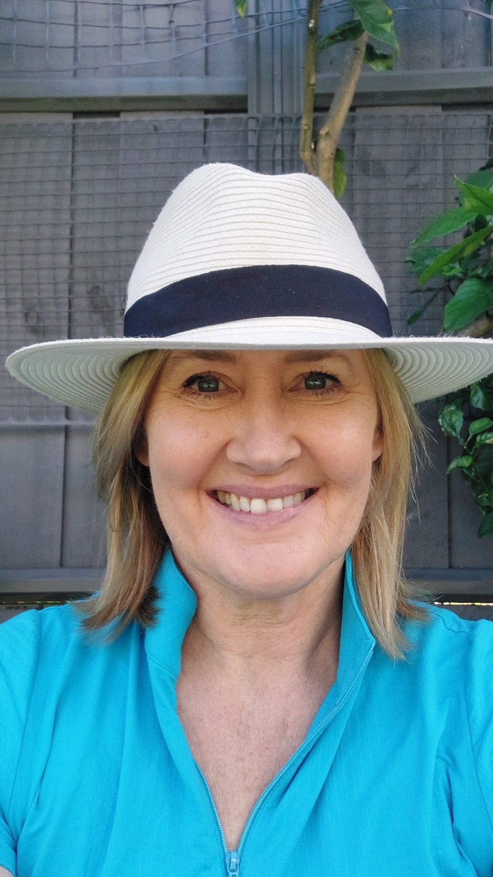 Anne Rollo wearing her white golf hat