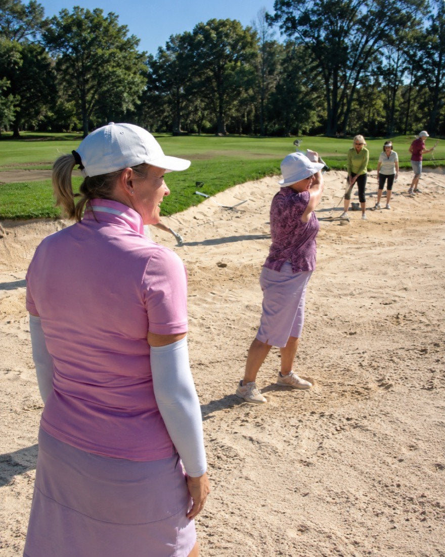 Anne coaching a student on the tee box