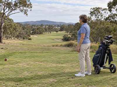 A golfer considering the next shot on a course